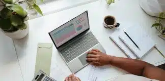 a person sitting at a table with a laptop